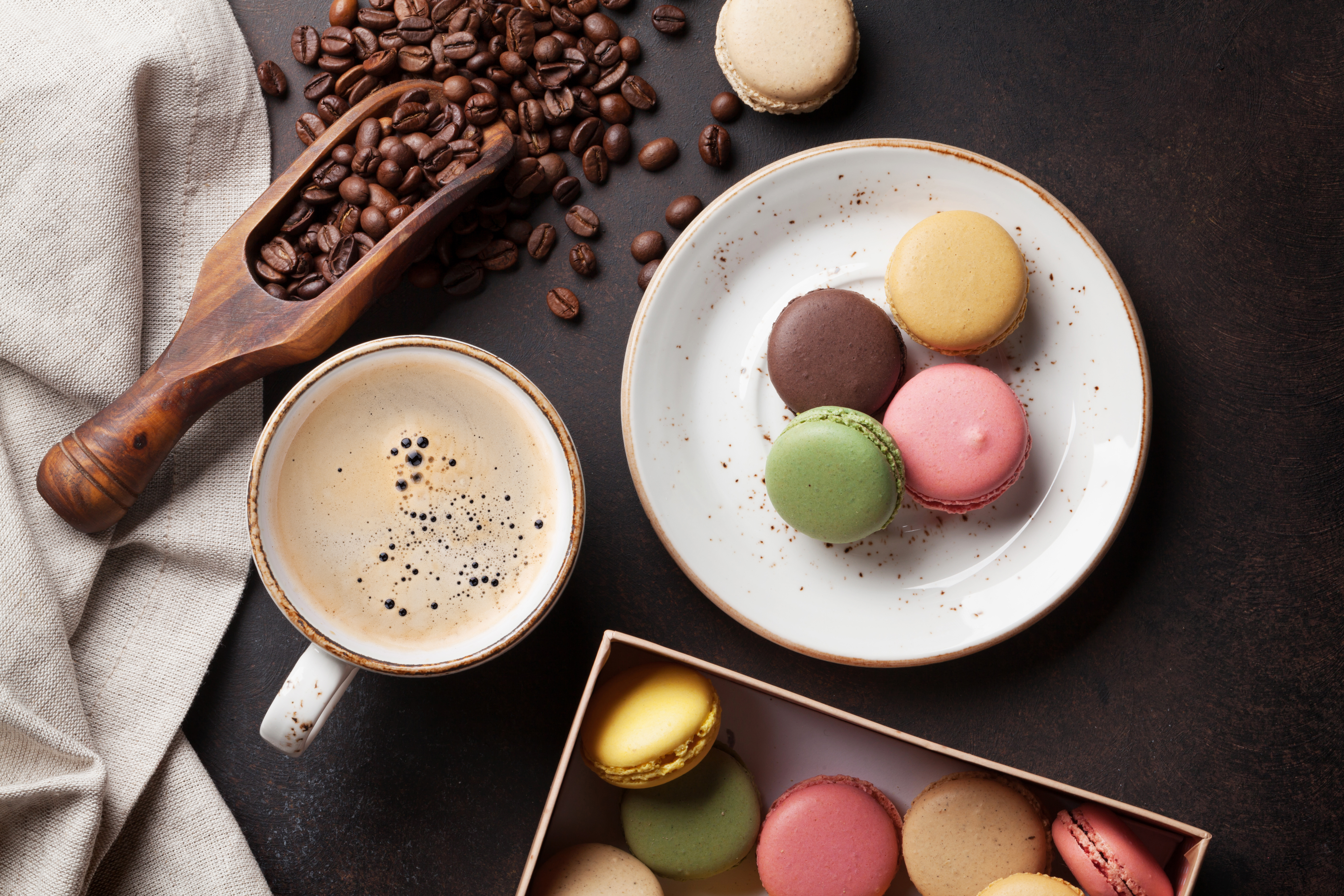 Coffee, chocolate and macaroons on old kitchen table