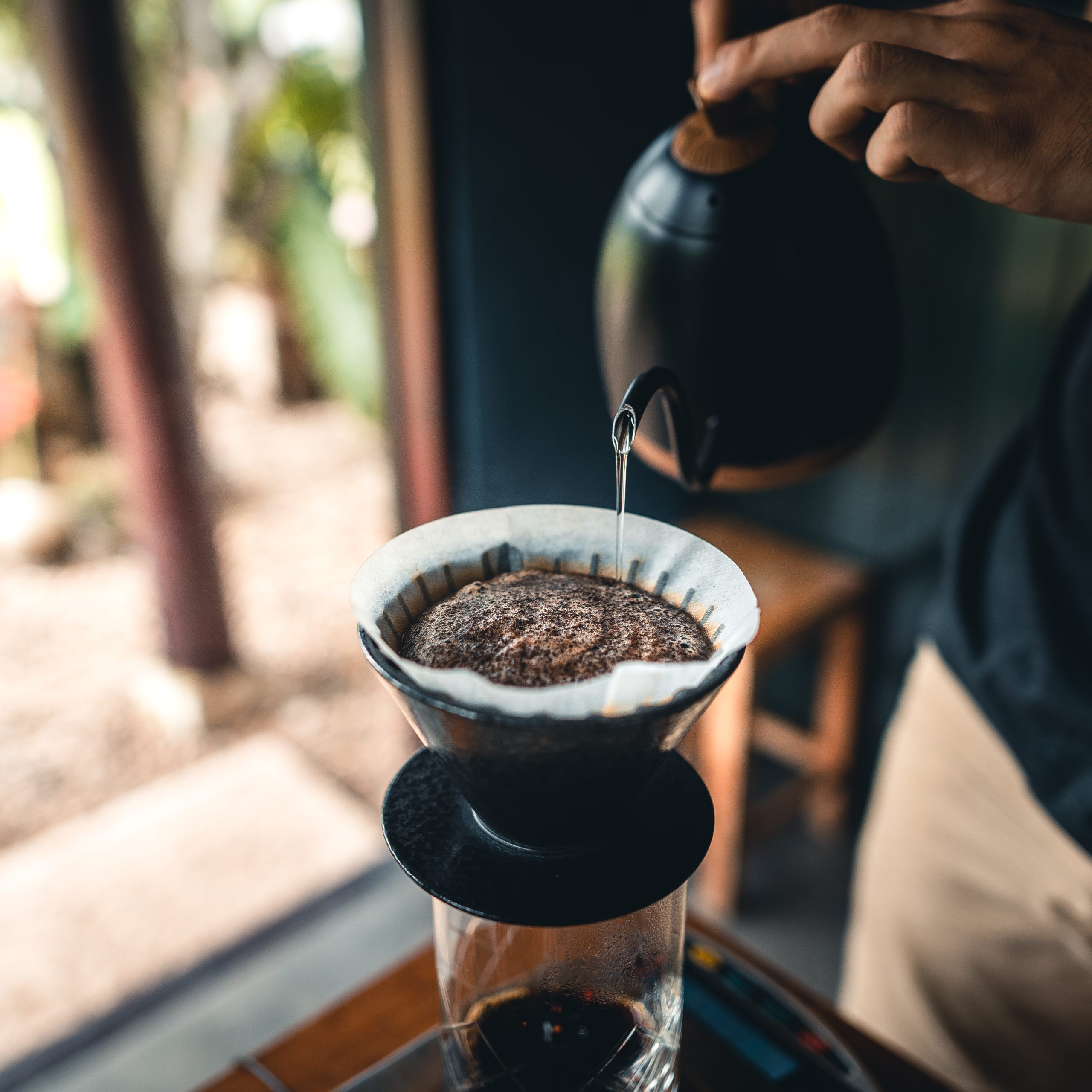 Professional barista preparing coffee pour over coffee maker and drip kettle